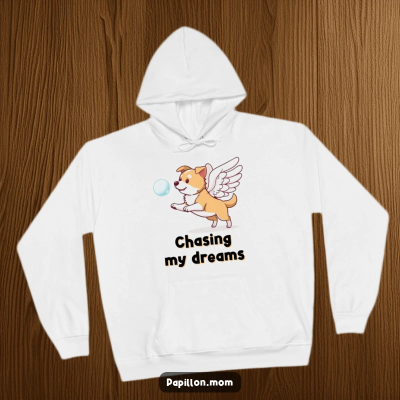 Funny hoodie depicting a dog with striking wings, playfully pursuing a translucent bubble, radiating a sense of wonder and lighthearted fun.