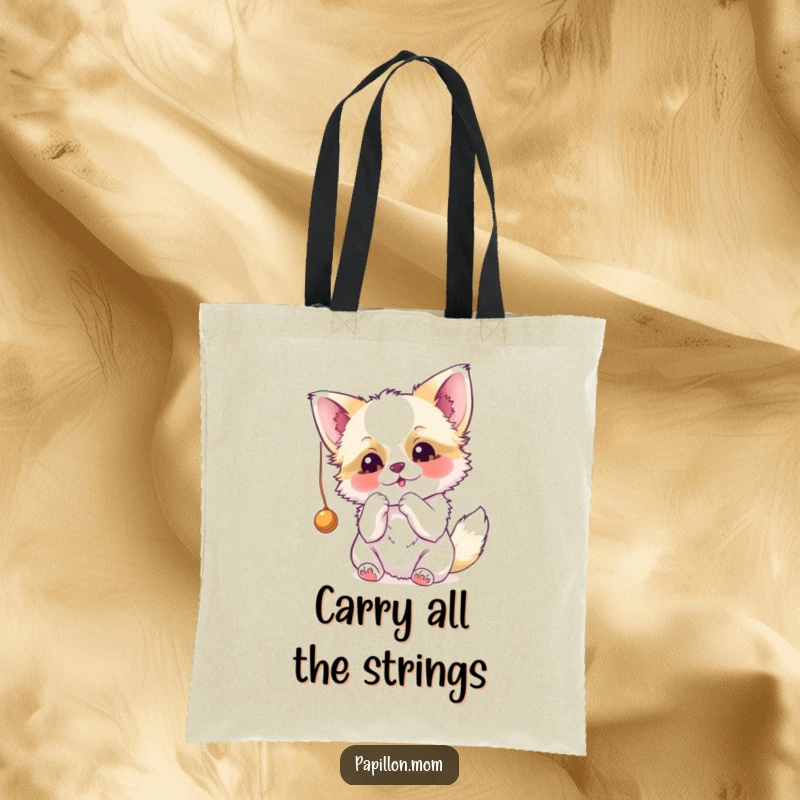 Funny Papillon tote bag showcasing a dog playfully swatting at a dangling string, embodying its energetic and cute nature.