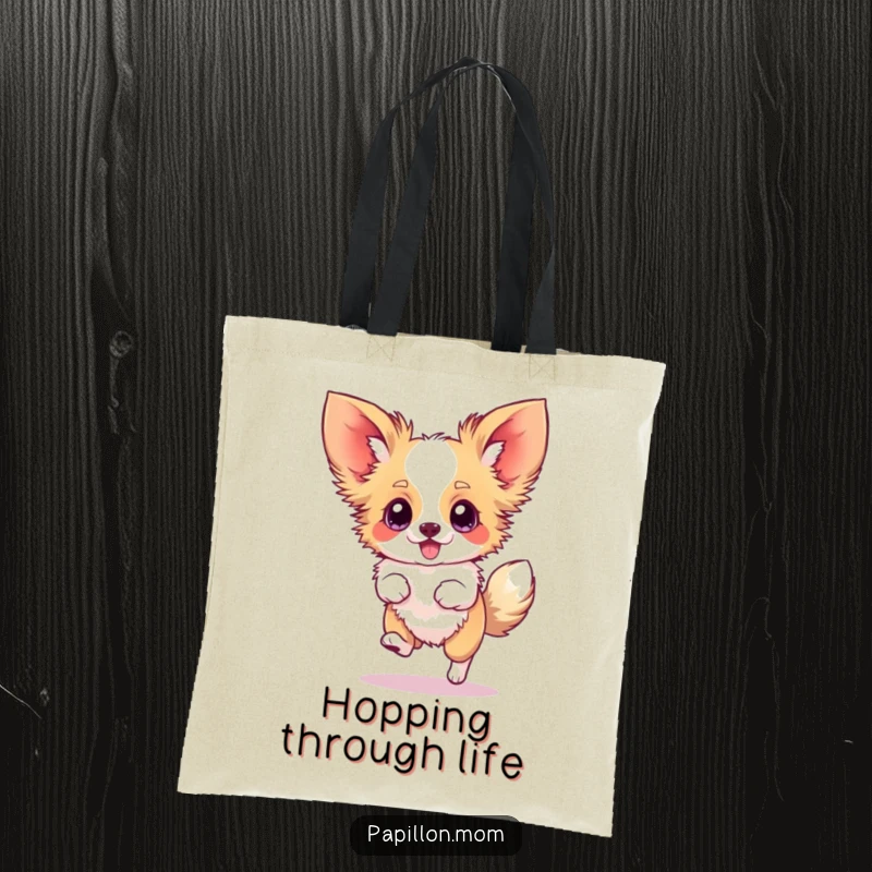 Funny Papillon tote bag showing a dog doing a silly hop with blurred ears, representing pure excitement and movement.